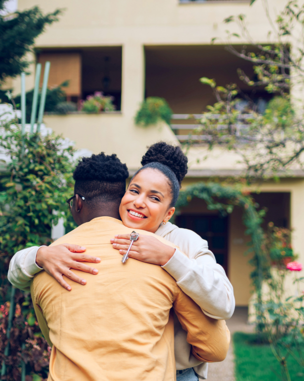 woman hugging her family member after receiving housing